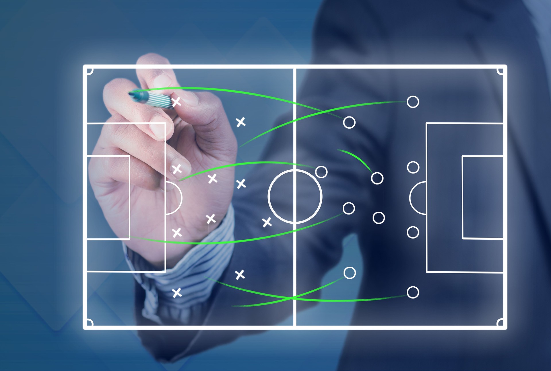 Game plan for a soccer game being edited by a man in a suit